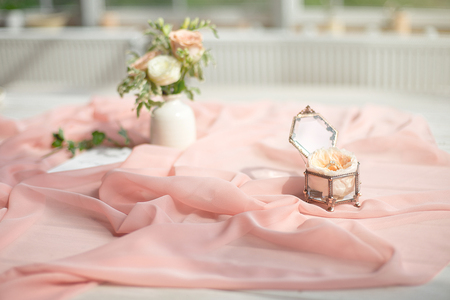 Beautiful engagement ring with flower in glass box on table.の写真素材