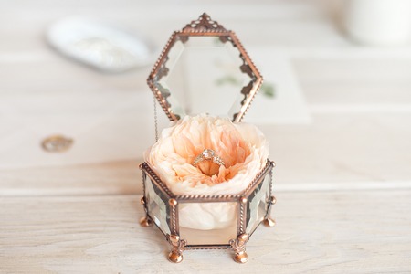 Wedding decor vintage glass square box with peony rose inside and wedding ring invitation card.
