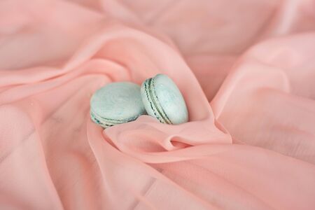 Cake French macaroons, sweet blue macaroons on a plate on a pink backgroundの写真素材