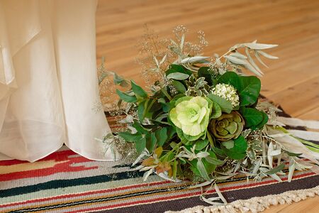 Slightly disheveled fresh and airy bridal bouquet with veronica and eucalyptus will be a great addition to the image of a stylish bride.の写真素材