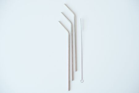 Lot of metal tubes for cocktails with schutkoy for cleaning isolated on white.の写真素材