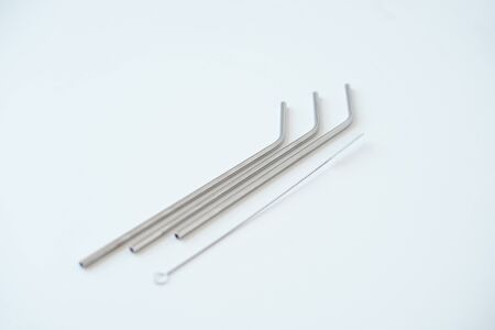 Lot of metal tubes for cocktails with schutkoy for cleaning isolated on white.