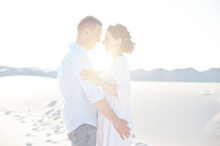 Loving couple kissing at sunset. love in the sun. Valentines day in nature beach.の写真素材