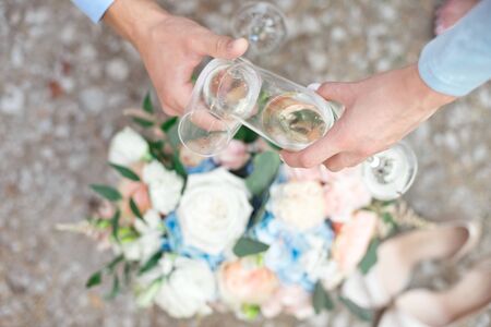 Bride and groom holding wedding champagne glassesの写真素材