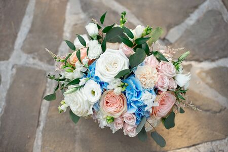 Gorgeous bouquet of roses, hydrangeas, ozotamnusa,eucalyptus on a beautiful concrete path.の写真素材