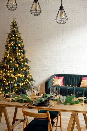 Christmas evening by candlelight. classic apartments with a white fireplace, decorated tree, sofa, large windows and chandelier.の写真素材