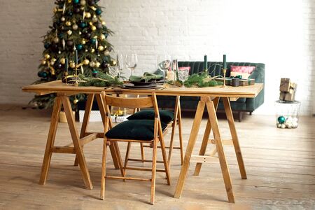 Table served for Christmas dinner in living room, close-up view, table setting, Christmas decorationの写真素材