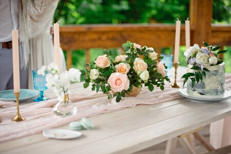 Wedding decoration table in the garden, floral arrangement, In the style vintage on outdoor. Wedding cake with flowers. Decorated table with flowers, served for two peopleの写真素材
