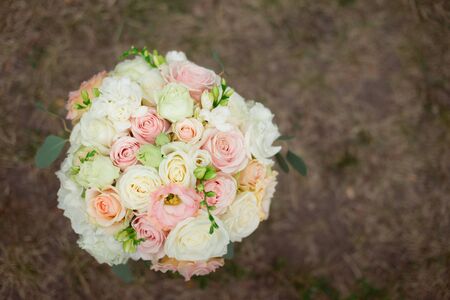 Top view of a beautiful delicate wedding bouquet of cream roses and eustoma.の写真素材