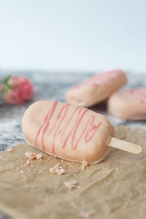 Ice cream pops cake on gray  with flowers.