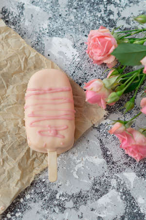 Ice cream pops cake on gray with flowers.の写真素材