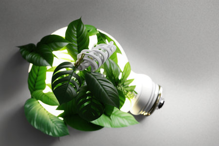 Leaves grow from the bulb LED light lamp, ECO energy concept. Saving Energy and Ecological Environment. Renewable and saving energy, eco or green power consumption concept, AI Generativeの素材