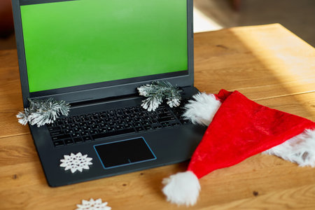 Christmas shopping online concept, Laptop with green screen placed on table with presents Christmas decorated , Table Top view of the desk with laptop, present boxesの写真素材