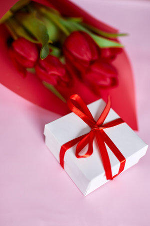 Top view red tulips flowers in red paper wrapper with gift box, festive background, concept of Happy Mother's day, Woman's day, birthday, 8 March, Valentines dayの写真素材