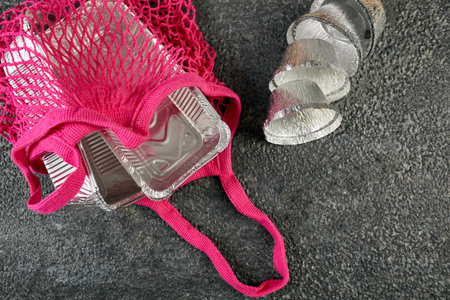 Flat lay of takeaway container in pink mash bag,  food delivery concept, food packaging, Take away food in boxes,の写真素材