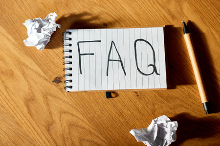 Faq, frequently asked questions text on notebook 
on wooden  background, Social Online Business communication,  concept.の写真素材