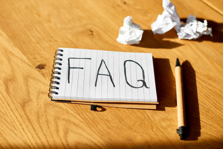 Faq, frequently asked questions text on notebook 
on wooden  background, Social Online Business communication,  concept.の写真素材