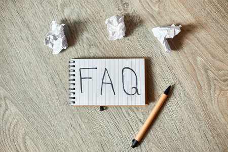 Faq, frequently asked questions text on notebook 
on wooden  background, Social Online Business communication,  concept.の写真素材