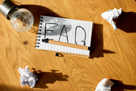Faq, frequently asked questions text on notebook on wooden  background, Social Online Business communication,  concept.の写真素材