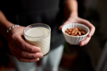 Male hands with glasse of vegan milk, Alternative types of non-dairy milks, plant milk made of various grain, Clean eating, Healthy diet.の写真素材