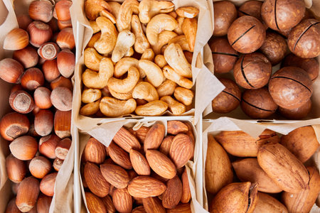 Assorted nuts in a wooden box nuts: pecan, almond, macadamia, brazil, cashew, hazelnut, Rich in minerals and protein. Healthy nutrition, high in zinc, magnesium and vitamins, online ordering, shoping concept.の写真素材
