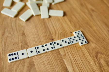 Top view of white domino games on wooden table background with copy space, board game conceptの写真素材