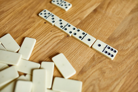 Top view of white domino games on wooden table background with copy space, board game conceptの写真素材