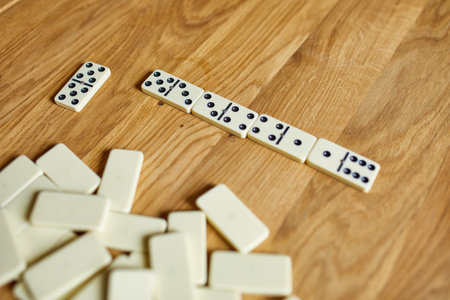 Top view of white domino games on wooden table background with copy space, board game conceptの写真素材