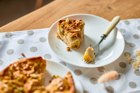 Piece of apple or pear pie, tart with caramel nuts on wooden table, copy space, top view.の写真素材