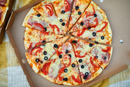 Two pizzas in the food carton on the grass, picnic concept, top view, copy space. Take away food, fastwood, italian pizza outdoor.の写真素材