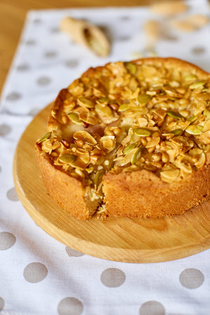 Apple or pear pie, tart with caramel nuts on wooden table, copy space, top view.の写真素材