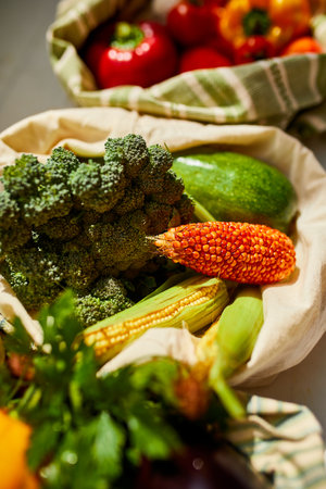 Top view assorted fresh vegetables in reusable cotton bags on table in the kitche in sunlight, groceries in textile Zero waste bags, Online grocery healthy shopping, vegan food.の写真素材