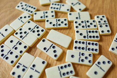Top view of white domino games on wooden table background with copy space, board game conceptの写真素材