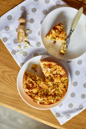 Piece of apple or pear pie, tart with caramel nuts on wooden table, copy space, top view.の写真素材