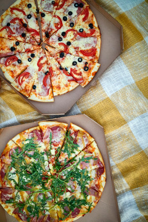 Two pizzas in the food carton on the grass, picnic concept, top view, copy space. Take away food, fastwood, italian pizza outdoor.の写真素材