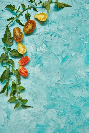 Flat lay Pattern composition with fresh ripe tomatoes on blue background with copy space,  Tasty and healthy food, top view.の写真素材