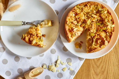 Piece of apple or pear pie, tart with caramel nuts on wooden table, copy space, top view.の写真素材
