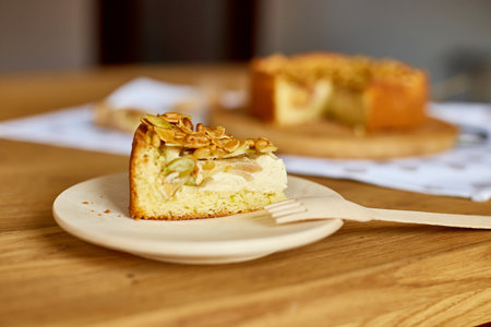Piece of apple or pear pie, tart with caramel nuts on wooden table, copy space, top view.の写真素材