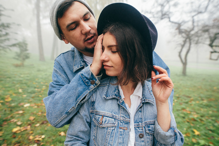Real happiness. Joyful loving couple hugging and smiling. They are looking at each other. Couple in love. Autumn atmosphere. Style.の写真素材