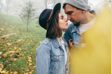 Real happiness. Joyful loving couple hugging and smiling. They are looking at each other. Couple in love. Autumn atmosphere. Style.の写真素材
