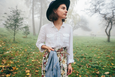 Street fashion concept. Vintage portrait of young woman in spring coat and hat. Fashion style womenの写真素材