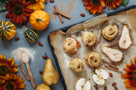 Autumn background: border from apples, pears and walnuts on old wooden table. Fall, Thanksgiving day and baking concept. Food frame, food background with copy space for textの写真素材