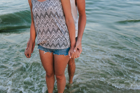 Beautiful girl and man at sunset on sandy bechの写真素材