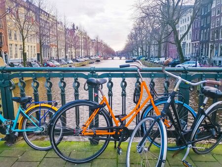 Parked bicycles on a canal bridge in Amsterdam. Tourism in the Netherlands.の写真素材