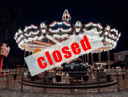 A warning sign that amusement parks are closed.