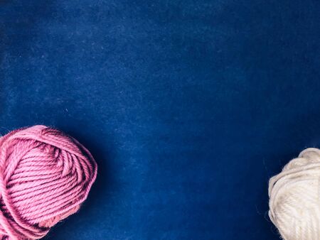 Skeins with threads for knitting on a background of color blue classic color of the year. Template...