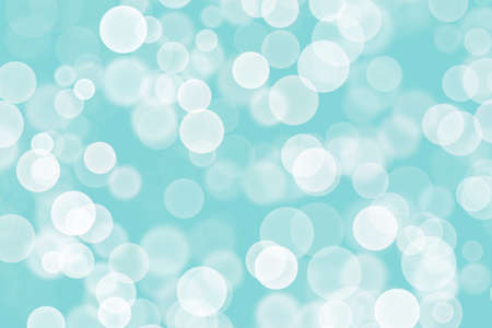 Beautiful blue background with many blurry white lights similar to bokeh.