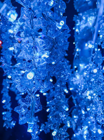 New Year's illumination, decoration of the city, houses, sale of illumination for the holidays. Glowing holiday lights.の写真素材
