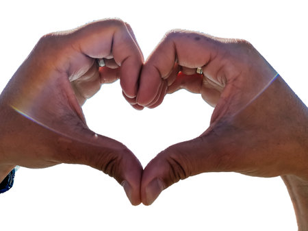 Man's hands isolated on a white background folded into a heart symbolizing love and feelings....
