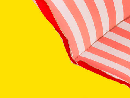 Part of a striped beach umbrella against a color of the year 2021 Illuminating, bottom view. Minimal summer concept.の写真素材